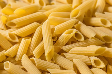Photo for Dry Organic Penne Pasta in a Bowl - Royalty Free Image