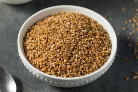Photo for Raw Brown Organic Bulgar Wheat in a Bowl - Royalty Free Image