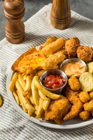 Photo for Deep Fried Appetizer Platter with French Fries Tots Mozzarella Sticks and Chicken - Royalty Free Image