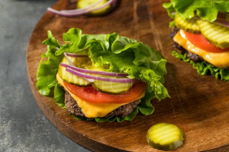 Glutenfreier Paleo Bunless Cheeseburger mit Salat und Tomate
