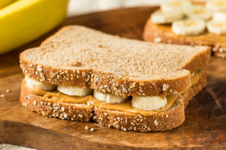 Foto de Sándwich de plátano de mantequilla de cacahuete saludable casero en pan de trigo - Imagen libre de derechos