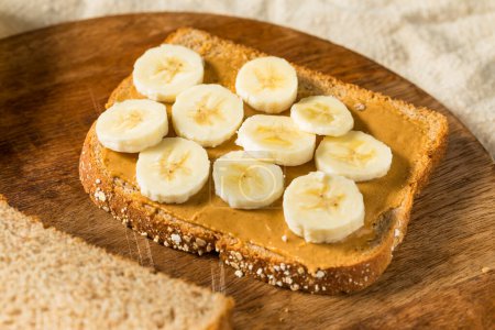 Photo for Homemade Healthy Peanut Butter Banana Sandwich on Wheat Bread - Royalty Free Image