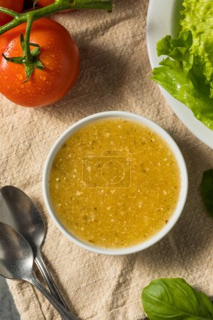 Photo for Organic Homemade Italian Salad Dressing with Garlic and Oil - Royalty Free Image