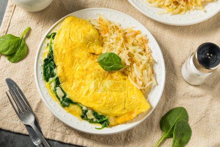 Photo for Homemade Spinach Florentine Omelet with Cheese and Potatoes - Royalty Free Image