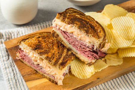 Photo for Homemade Russian Reuben Sandwich with Cheese and Chips - Royalty Free Image