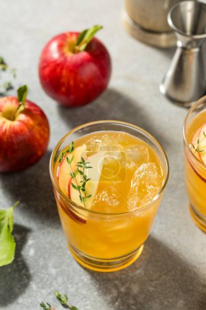 Photo for Fresh Sweet Apple Cider Cocktail with Bourbon and Thyme - Royalty Free Image