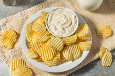 Photo for Organic Crinkle Potato Chips and French Onion Dip Ready to Eat - Royalty Free Image