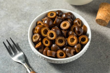 Photo for Organic Sliced Black Brown Olives in a Bowl - Royalty Free Image