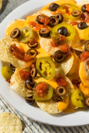 Photo for Homemade Basic Mexican Nachos with Cheese Jalapeno and Olives - Royalty Free Image