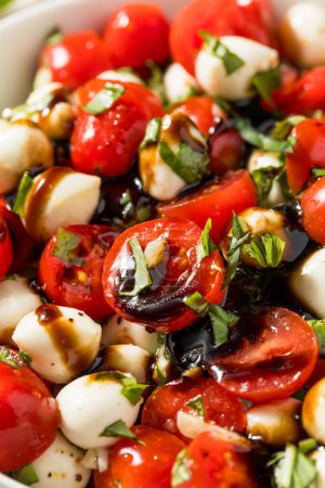 Photo for Organic Healthy Caprese Salad with Mozzarella Tomato and Basil - Royalty Free Image