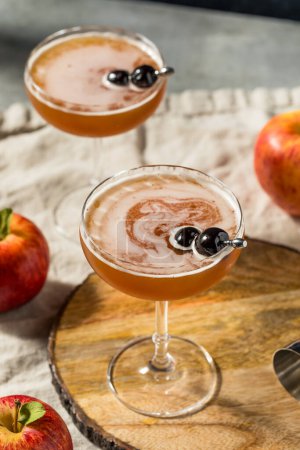 Photo for Cold Refreshing Apple Cider Manhattan Cocktail with Bourbon and Vermouth - Royalty Free Image