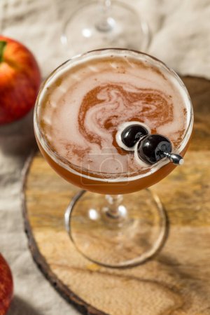 Photo for Cold Refreshing Apple Cider Manhattan Cocktail with Bourbon and Vermouth - Royalty Free Image