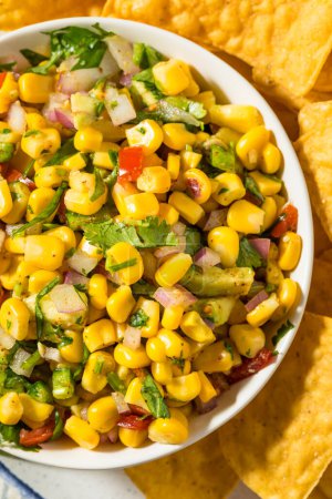 Photo for Homemade Organic Corn Salsa with Tortilla Chips - Royalty Free Image