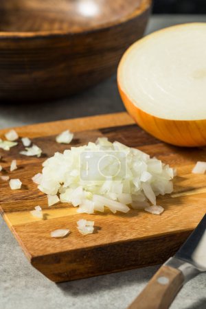 Photo for Raw Organic Yellow Diced Onions on a Cutting Board - Royalty Free Image