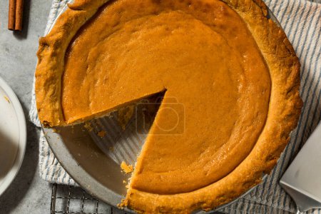 Photo for Homemade Orange Thanksgiving Pumpkin Pie Ready to Eat - Royalty Free Image