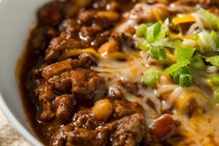 Photo for Organic Homemade Turkey Chili Con Carne with Cheese and Green Onions - Royalty Free Image