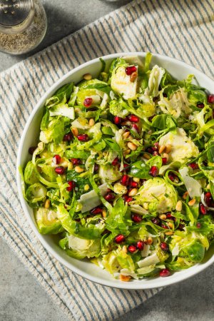Photo for Raw Organic Brussels Sprouts Salad with Cheese and Pomegranate - Royalty Free Image