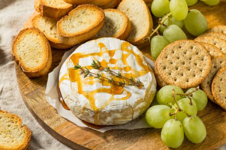 Photo for Homemade Baked Brie Appetizer with Grapes and Crackers - Royalty Free Image