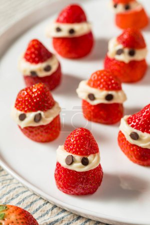 Photo for Homemade Festive Christmas Strawberry Santas with Whipped Cream and Chocolate - Royalty Free Image