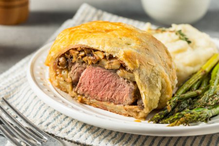 Photo for Homemade Individual Beef Wellingtons with Asparagus and Potatoes - Royalty Free Image