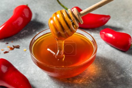 Photo for Organic Raw Spicy Hot Honey in a Bowl with Dipper - Royalty Free Image