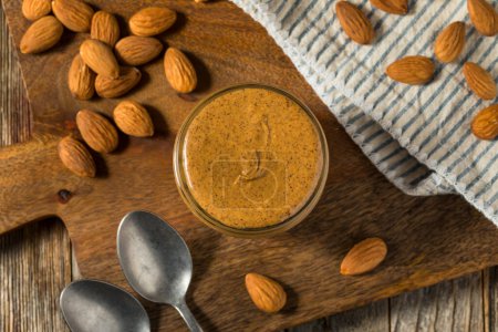 Photo for Organic Sweet Crunchy Almond Nut Butter in a Jar - Royalty Free Image