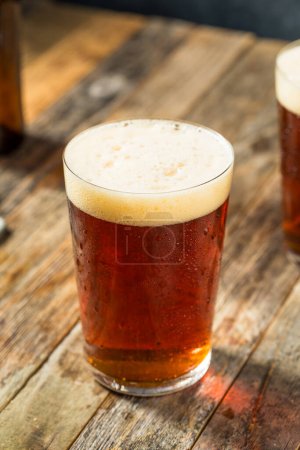 Photo for Boozy Cold Dark Amber Craft Beer in a Pint Glass - Royalty Free Image