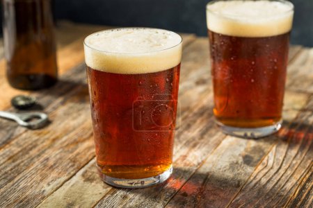 Photo for Boozy Cold Dark Amber Craft Beer in a Pint Glass - Royalty Free Image