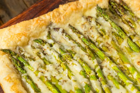 Photo for Homemade Baked Puff Pastry Asparagus Tart with Cheese for an Appetizer - Royalty Free Image