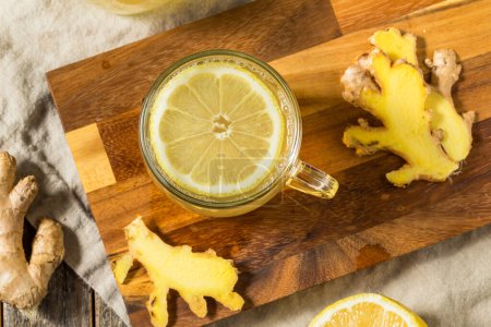 Photo for Warm Healthy Ginger Lemon Tea in a Glass Mug - Royalty Free Image