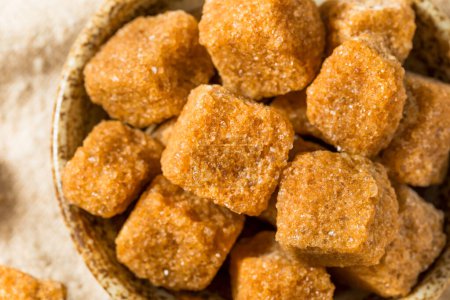 Photo for Sweet Brown Raw Sugar Cubes in a Bowl - Royalty Free Image