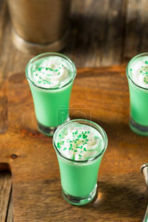 Photo for Boozy Green Grasshopper Shots Cocktails with Whipped Cream - Royalty Free Image