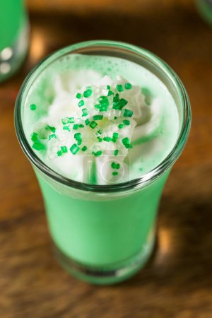 Photo for Boozy Green Grasshopper Shots Cocktails with Whipped Cream - Royalty Free Image