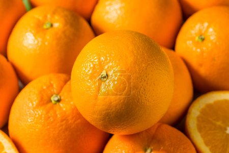 Photo for Raw Organic Juicy Oranges in a Bunch with Leaves - Royalty Free Image