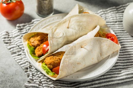 Photo for Healthy Homemade Fried Chicken Wrap with Tomato and Lettuce - Royalty Free Image