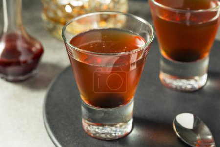 Photo for Boozy Bourbon Whiskey Manhattan Cocktail with a Cherry - Royalty Free Image