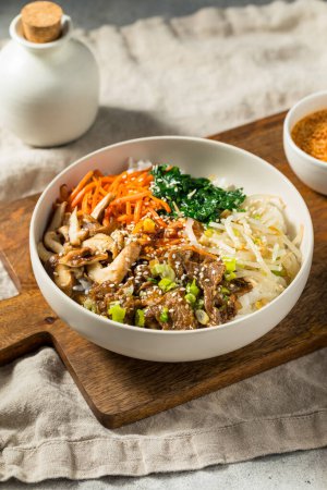 Photo for Hearty Korean Bibimbop Dish with Beef Mushrooms Carrots and Rice - Royalty Free Image