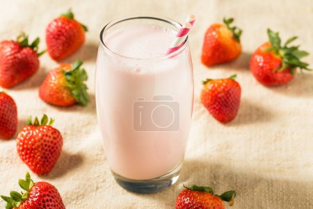 Photo for Healthy Pink Strawberry Milk in a Glass with a Straw - Royalty Free Image