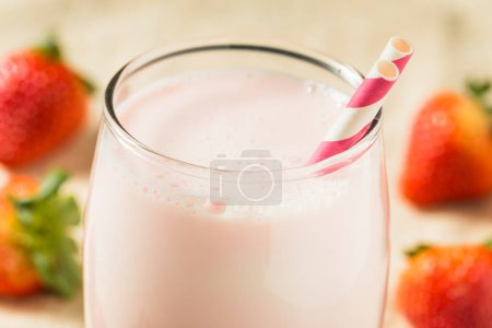 Photo for Healthy Pink Strawberry Milk in a Glass with a Straw - Royalty Free Image