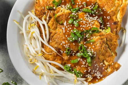 Photo for Fried Chinese Egg Foo Young  with Sauce and Rice - Royalty Free Image