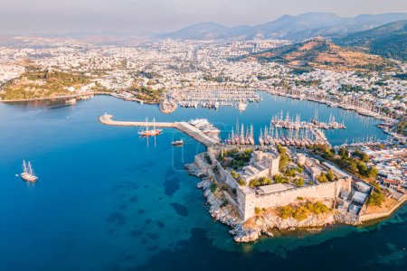 Bodrum ancient castle with Bodrum marina at sunrise, aerial view