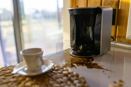 Photo for Spilled coffee on a table on kitchen table in bad morning, close-up - Royalty Free Image
