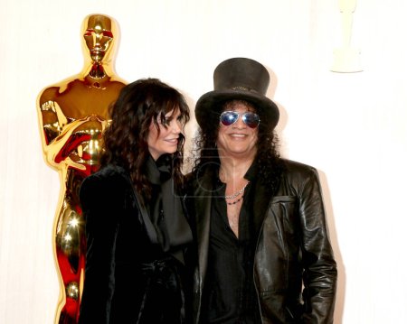 Photo for LOS ANGELES - MAR 10:  Meegan Hodges, Slash at the 96th Academy Awards Arrivals at the Dolby Theater on March 10, 2024 in Los Angeles, CA - Royalty Free Image
