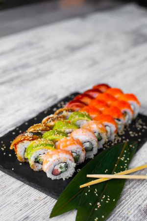 Photo for Assorted japanese sushi rolls on black background. Asian or Japanese food frame - Royalty Free Image