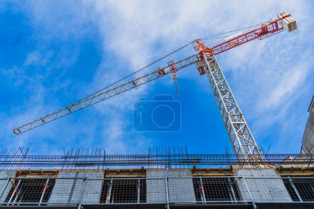 Photo for One construction crane for the construction of high-rise buildings and offices against the blue sky close-up, construction concept, bottom view - Royalty Free Image