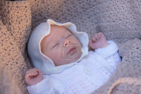 Photo for Beautiful portrait of adorable mixed ethnicity Asian Caucasian baby girl a few weeks old lying on baby cart sleeping peacefully wearing a sweet hat in new life and newborn concept - Royalty Free Image