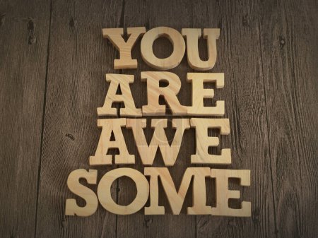 You are awesome, text words typography written with wooden letter, life and business motivational inspirational concept