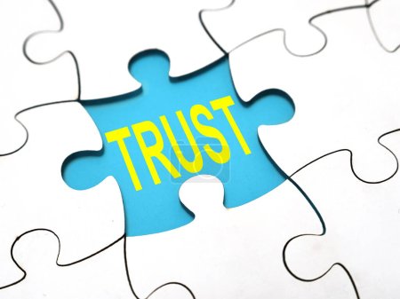 Trust, text words typography written under jigsaw puzzle, life and business motivational inspirational concept