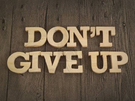 Foto de Don't give up, text words typography written with wooden letter, life and business motivational inspirational concept - Imagen libre de derechos