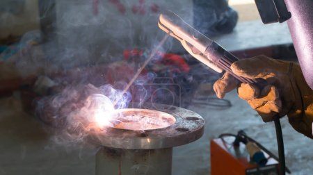 Photo for Welder performs welding work semi-automatic electric arc welding. MIG welding. - Royalty Free Image
